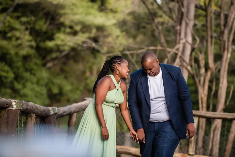 Wedding couple holding hands in nature setting.