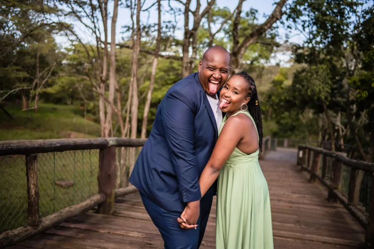Happy Kenyan couple embracing at Nairobi Safari Walk, showcasing their love amidst nature.
