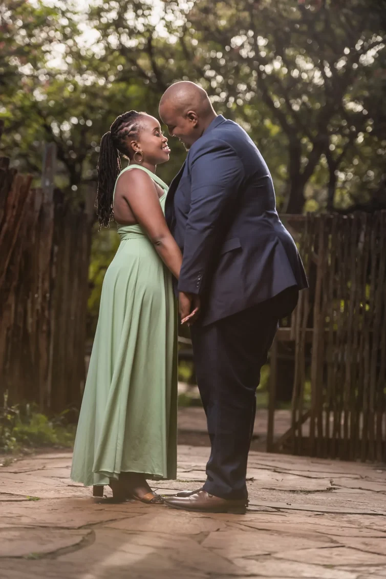 Elegant Kenyan couple sharing a romantic moment outdoors.